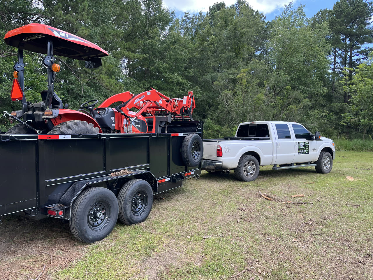 Southern Style truck with tractor on dump trailer at job site